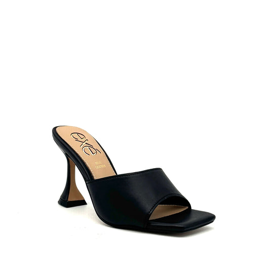 Black: EXE Bianca-700 wide-band sculptural heel slide sandal in black with flared heel and square toe, side view
