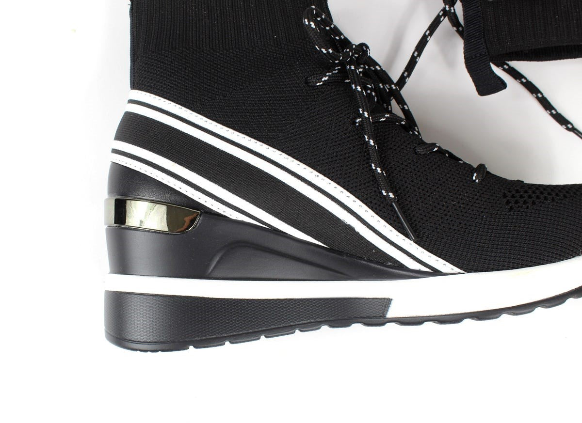 Close-up of Renato Garini WEX23 black high-top wedge sneaker showing white diagonal stripes, metallic heel accent and raised black-and-white sole