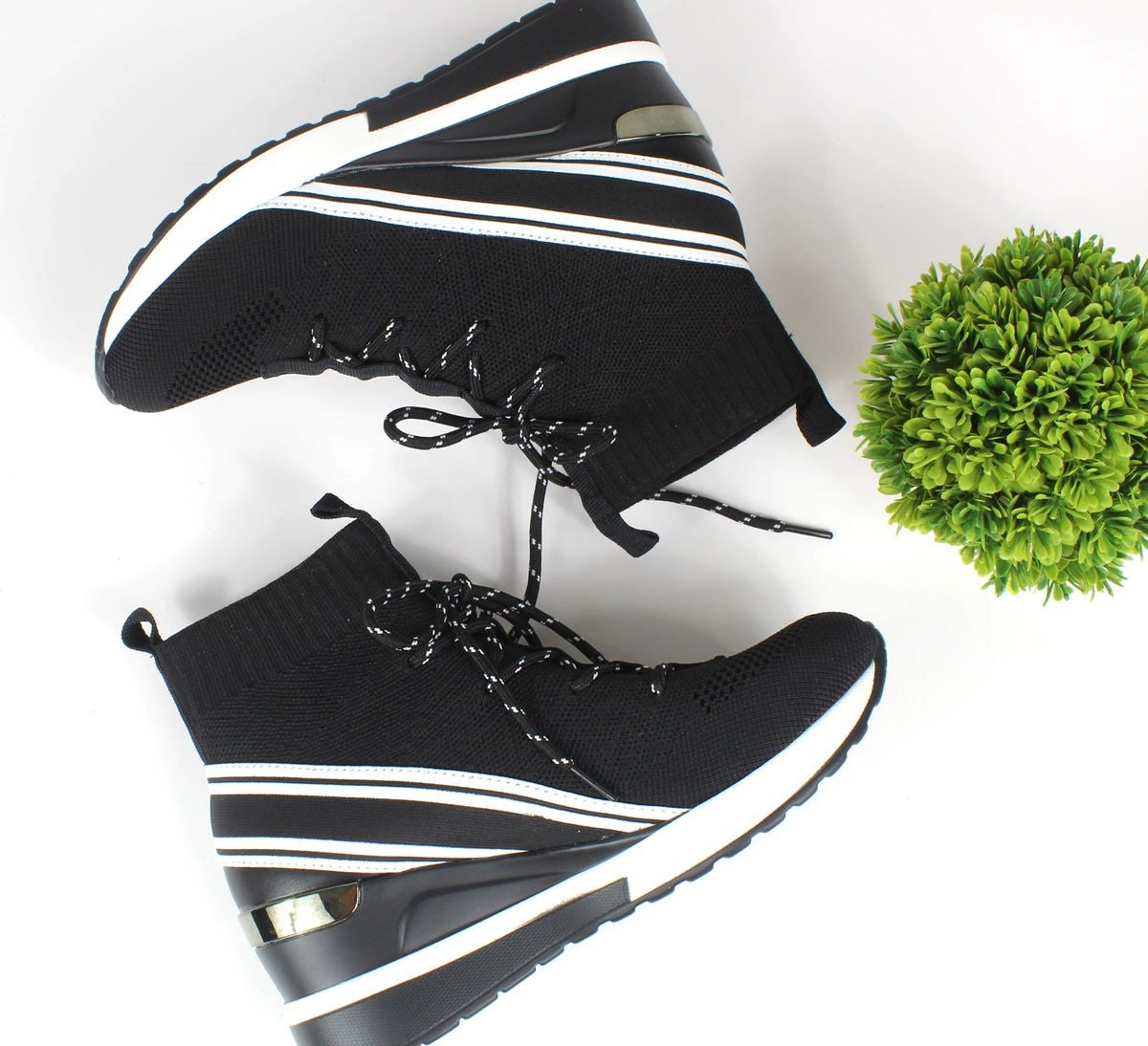 Renato Garini WEX23 black lace-up high-top wedge sneakers in a flat-lay arrangement, showing white diagonal stripes and metallic heel accents