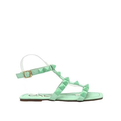 Mint: EXE 2269-2781 pyramid stud T-strap flat sandal in mint with gold-tone ankle buckle and square toe, side view