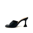 Black: EXE Bianca-700 wide-band sculptural heel slide sandal in black with flared heel and square toe, side view