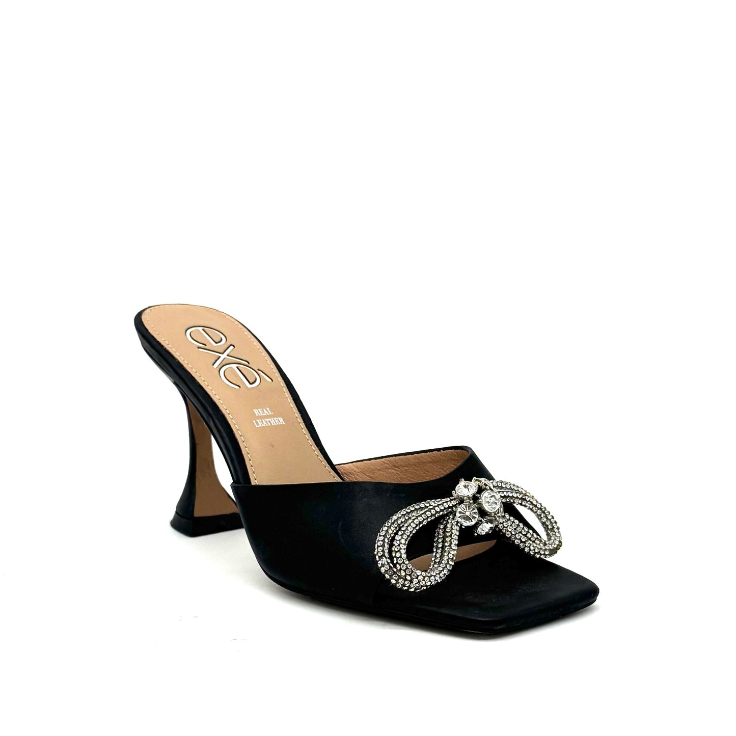 Black: EXE Bianca-755 crystal brooch heeled slide sandal in black with rhinestone tassel embellishment and sculptural flared heel, side view