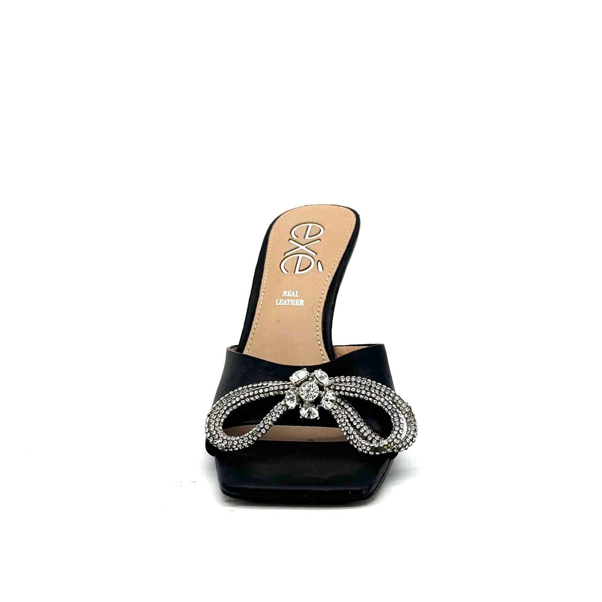 Black: EXE Bianca-755 crystal brooch heeled slide sandal in black with rhinestone tassel embellishment and sculptural flared heel, side view