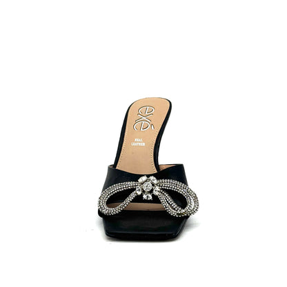 Black: EXE Bianca-755 crystal brooch heeled slide sandal in black with rhinestone tassel embellishment and sculptural flared heel, side view
