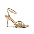 EXE Joy-959 crystal-embellished caged heel sandal in gold with rhinestone lattice straps, ankle strap buckle, and jeweled sculptural heel, side view
