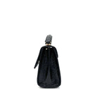 Black patent leather Karya Mila top handle satchel with embossed texture and gold hardware