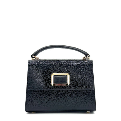 Black patent leather Karya Mila top handle satchel with embossed texture and gold hardware