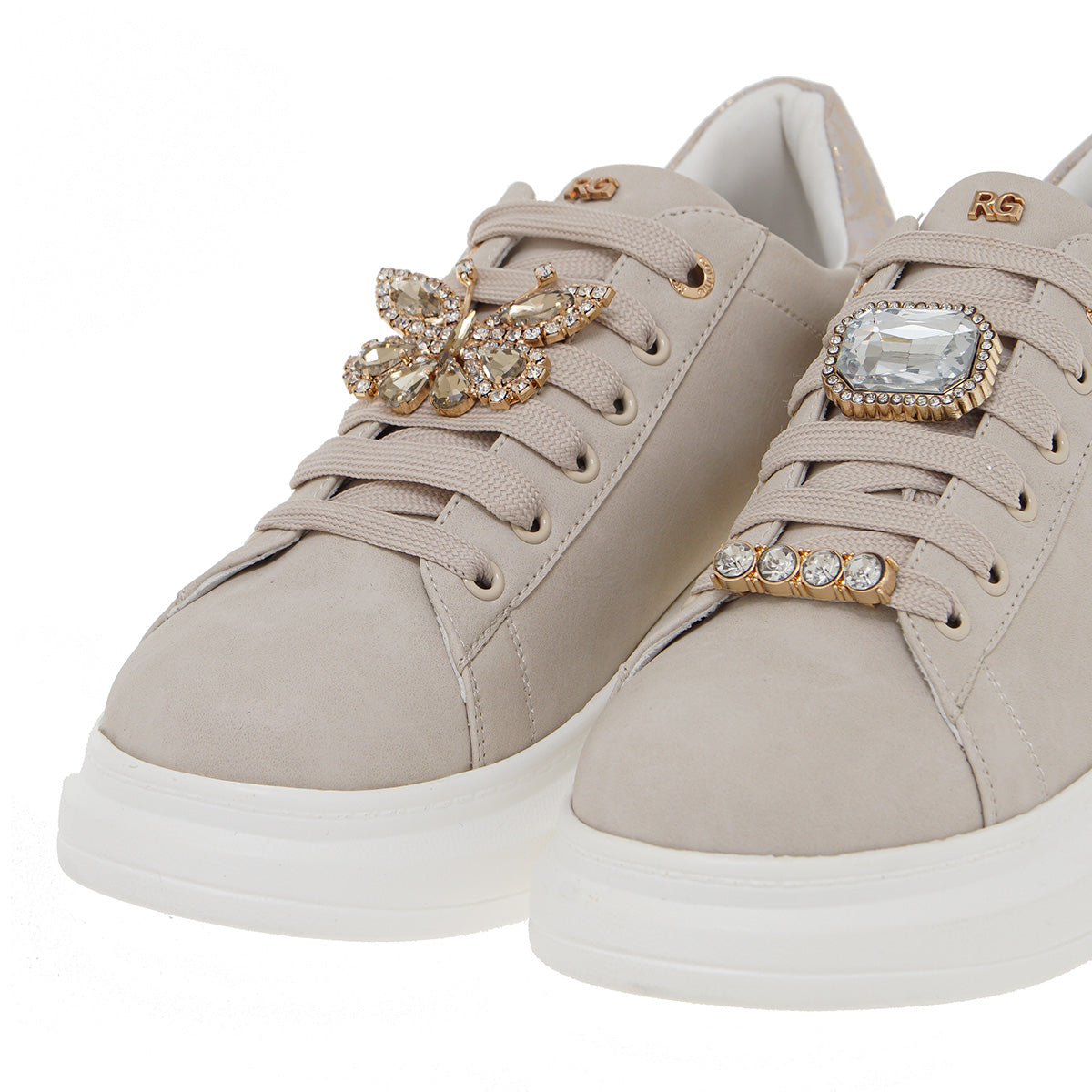 Close-up of Renato Garini Butterfly beige sneakers showing jeweled butterfly lace ornaments and white platform soles