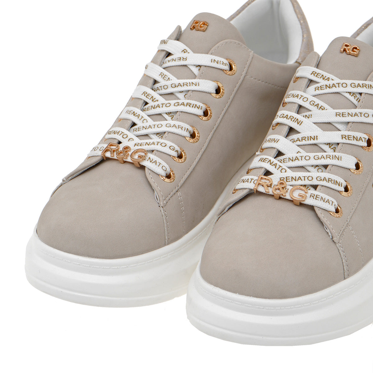 Close-up of Renato Garini EX166 beige platform sneakers showing lace-up fronts, gold-tone details and rounded toes