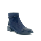 Spring Step Shelbi genuine leather ankle boot in navy with patent cap toe, studded ankle strap and block heel, three-quarter view