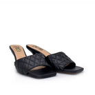 Black: EXE Jennifer-566 quilted slide mule in black with square toe and sculptural low heel
