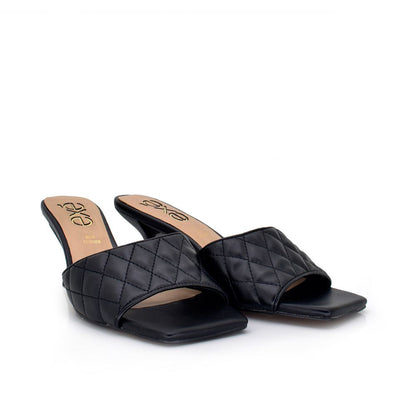 Black: EXE Jennifer-566 quilted slide mule in black with square toe and sculptural low heel
