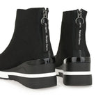 Rear detail of Renato Garini 34-210 black ankle boots with black branded zipper pulls, glossy heel trim and contrasting white stripes on the wedge soles