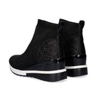 Pair of Renato Garini EX02B black rhinestone wedge ankle boots from a rear three-quarter angle, showing sparkling heel panels and pull tabs