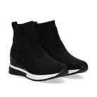 Pair of Renato Garini EX02B black rhinestone sock wedge ankle boots at a three-quarter angle, showing ribbed collars and black-and-white soles