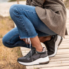 Renato Garini EX34 grey embellished wedge sneakers styled with cropped blue jeans and a checked jacket, worn outdoors